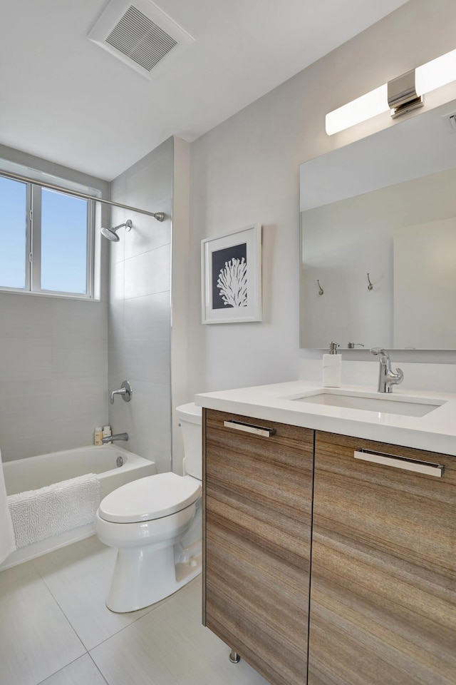 full bathroom with tile patterned floors, vanity, toilet, and tiled shower / bath