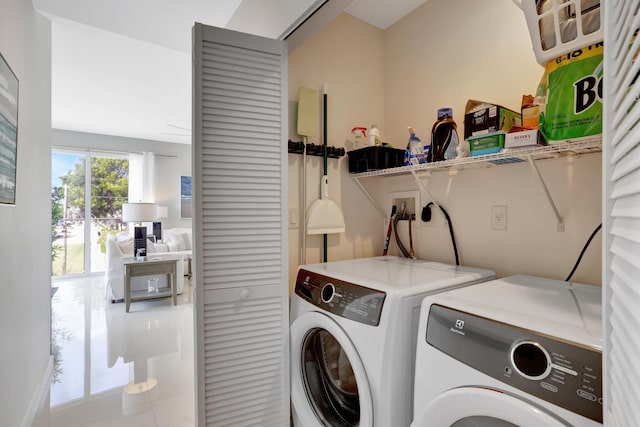 washroom with separate washer and dryer and tile patterned flooring