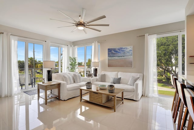 living room featuring a wealth of natural light, light tile patterned floors, and ceiling fan