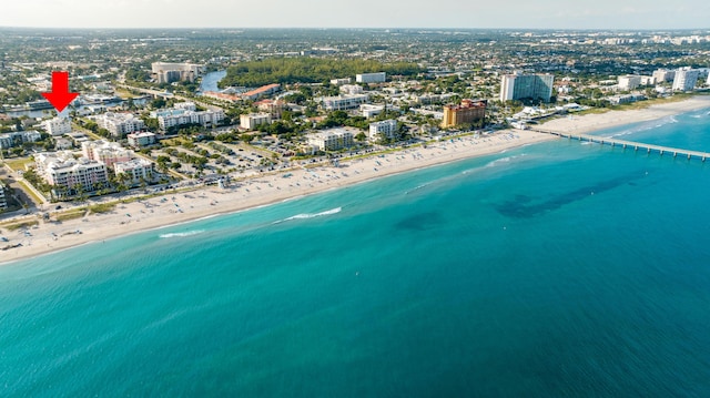 bird's eye view featuring a water view and a view of the beach