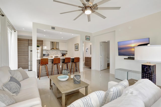 living room with ceiling fan and light tile patterned floors