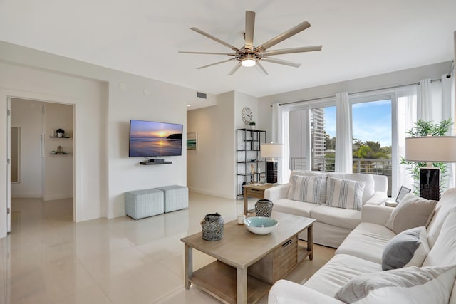 tiled living room featuring ceiling fan