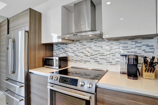 kitchen with tasteful backsplash, stainless steel appliances, and wall chimney range hood