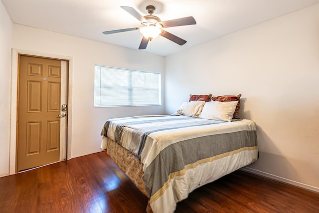 bedroom featuring ceiling fan and dark wood-type flooring