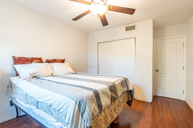 bedroom with a closet, ceiling fan, and dark wood-type flooring