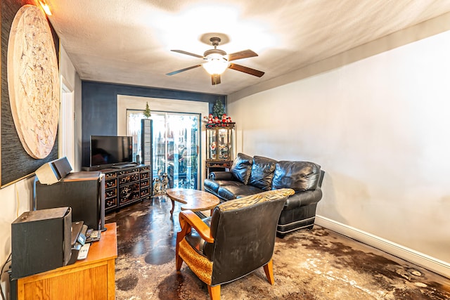 living room with a textured ceiling and ceiling fan