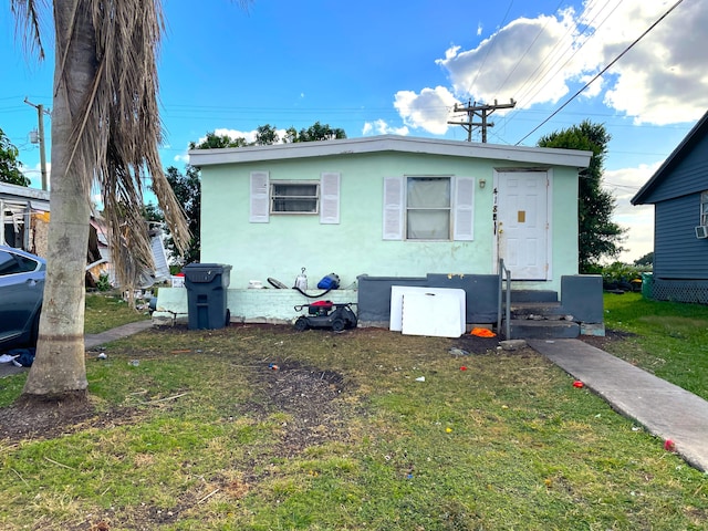 bungalow-style house with a front yard