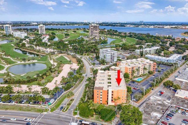 birds eye view of property with a water view, view of golf course, and a view of city