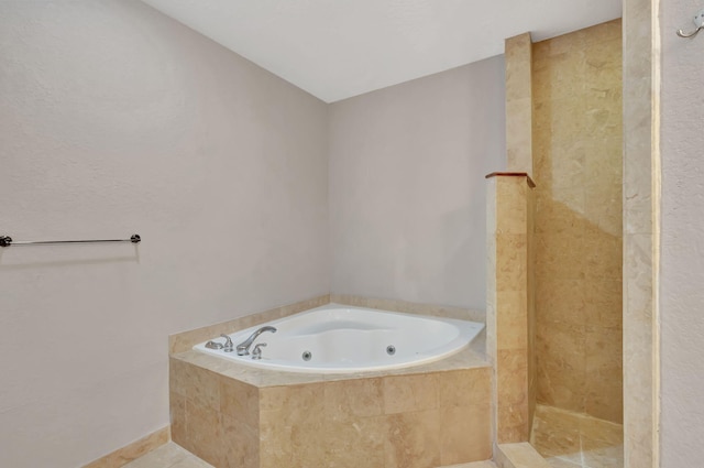 full bathroom featuring tile patterned flooring, a whirlpool tub, and a tile shower