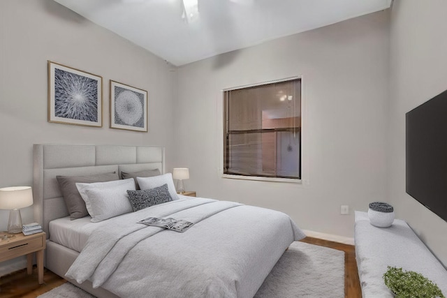 bedroom with baseboards and wood finished floors