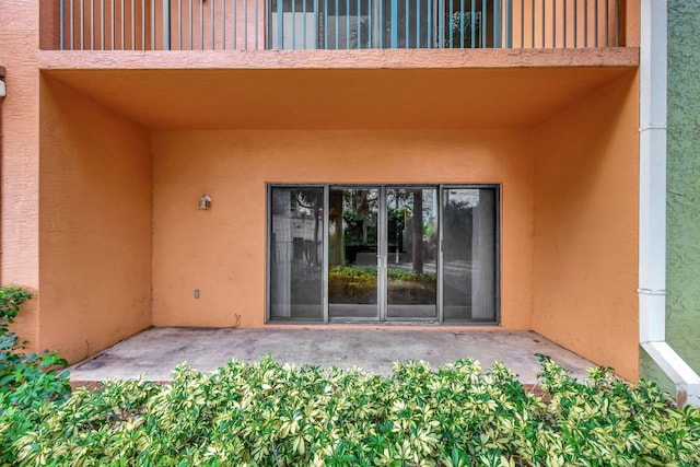 view of exterior entry featuring stucco siding