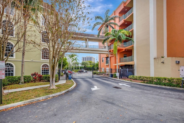 view of street featuring curbs, a gated entry, and a gate