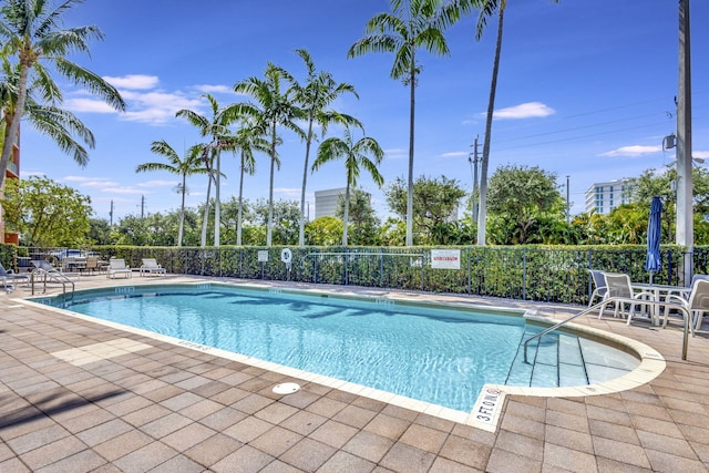 pool featuring a patio area and fence