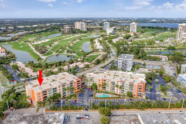 drone / aerial view featuring a water view, a view of city, and golf course view