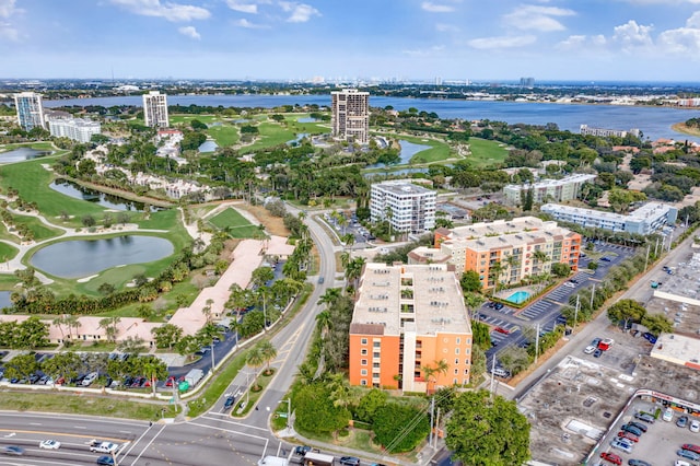 bird's eye view featuring view of golf course, a view of city, and a water view