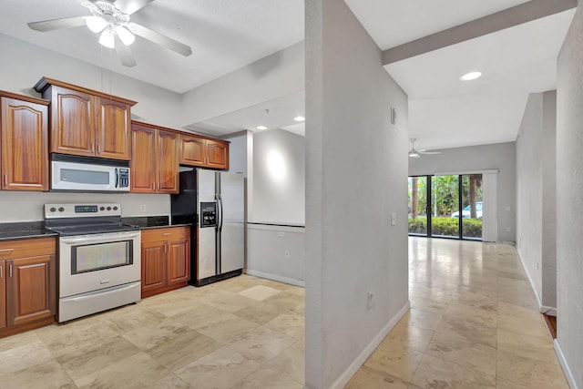 kitchen with a ceiling fan, electric stove, dark countertops, refrigerator with ice dispenser, and brown cabinets