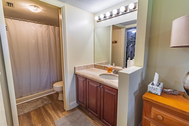 full bath featuring visible vents, toilet, vanity, wood finished floors, and a shower with curtain