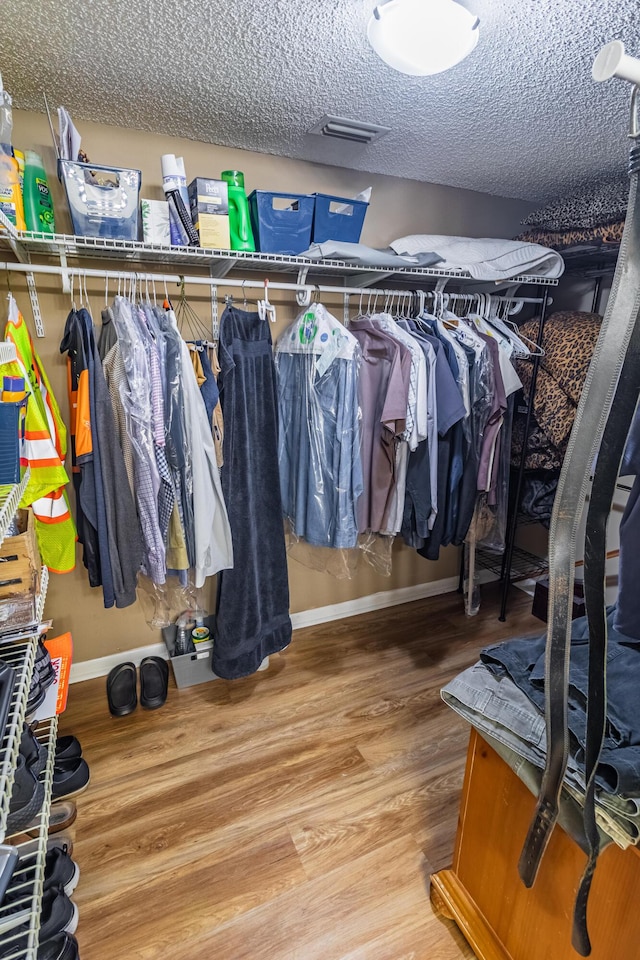 walk in closet featuring wood finished floors