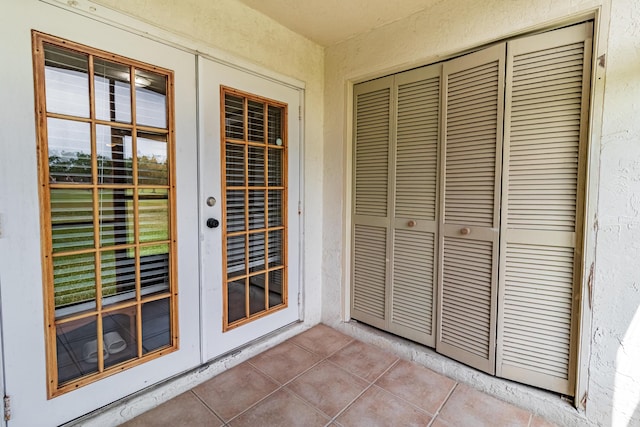 doorway to property featuring french doors and stucco siding