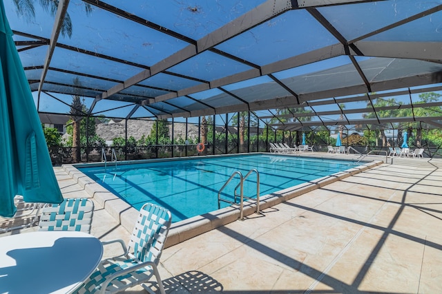 pool featuring a lanai and a patio area