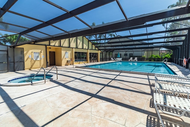 pool with a lanai, a patio, and a hot tub