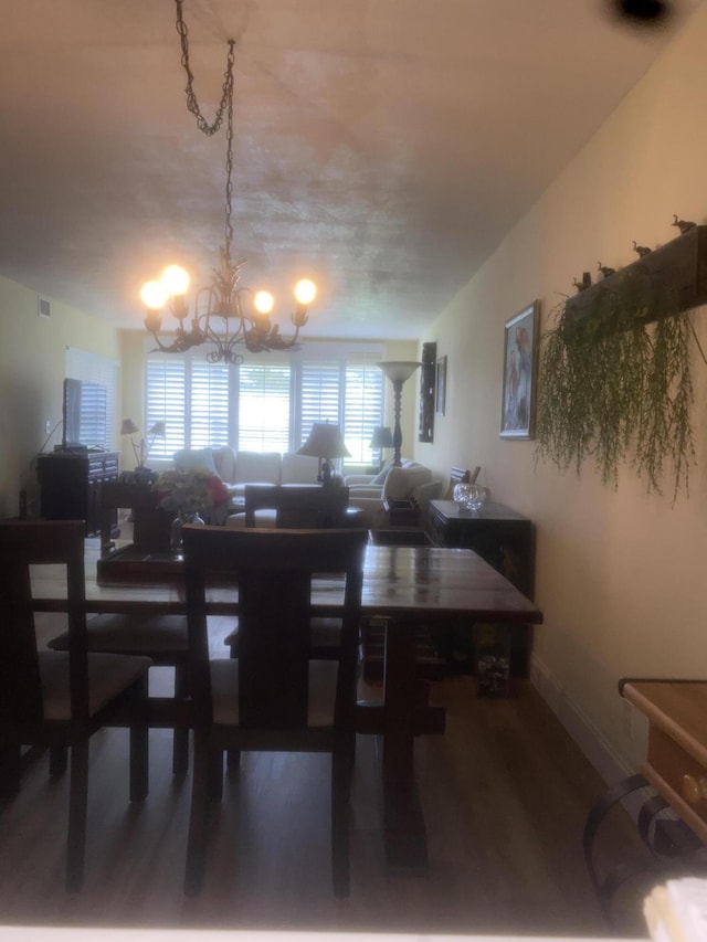 dining room with a chandelier and wood-type flooring