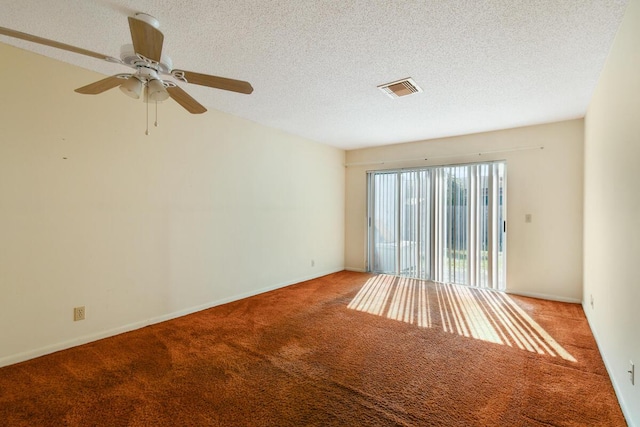 carpeted empty room with ceiling fan and a textured ceiling