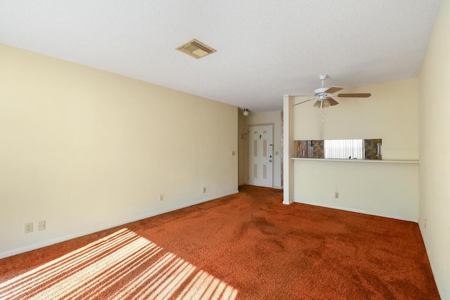 unfurnished living room featuring carpet, ceiling fan, and a textured ceiling