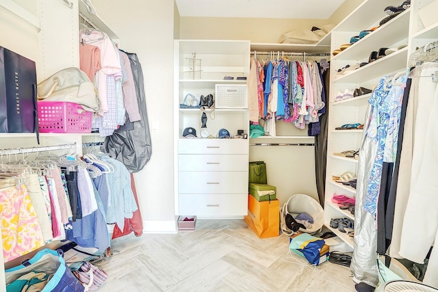 spacious closet with light parquet flooring