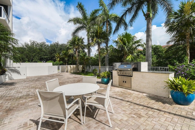 view of patio with area for grilling and a grill