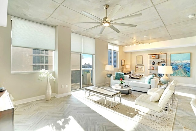 living room featuring light parquet floors and ceiling fan