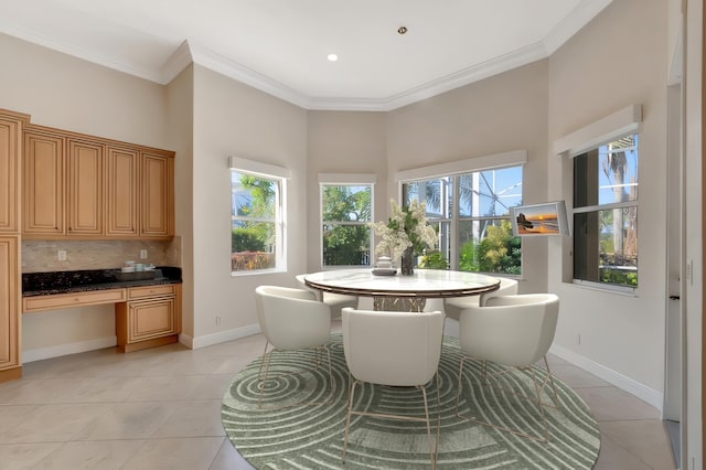 dining area featuring light tile patterned floors and ornamental molding