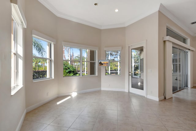 empty room with light tile patterned flooring and crown molding