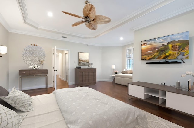 bedroom with a raised ceiling, ceiling fan, dark hardwood / wood-style flooring, and ornamental molding