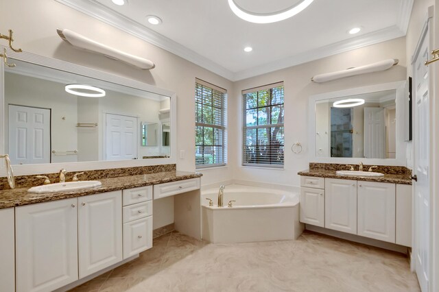 bathroom with tile patterned floors, a tub, vanity, and ornamental molding