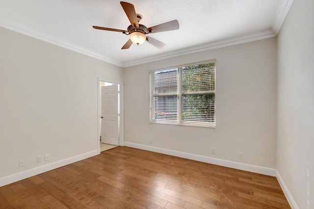 empty room featuring hardwood / wood-style flooring, ceiling fan, and crown molding