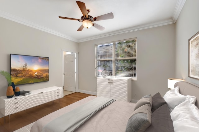 bedroom with hardwood / wood-style flooring, ceiling fan, and ornamental molding