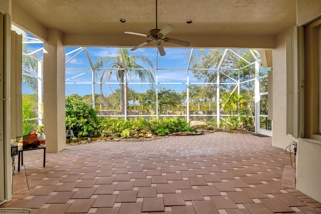 unfurnished sunroom with ceiling fan