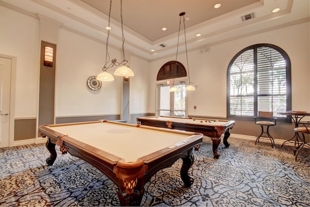 rec room with pool table, a towering ceiling, a tray ceiling, carpet, and ornamental molding