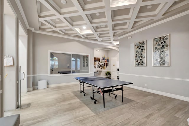 playroom featuring beam ceiling, ornamental molding, coffered ceiling, and light wood-type flooring