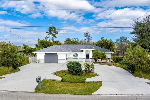 ranch-style home with a front yard and a garage