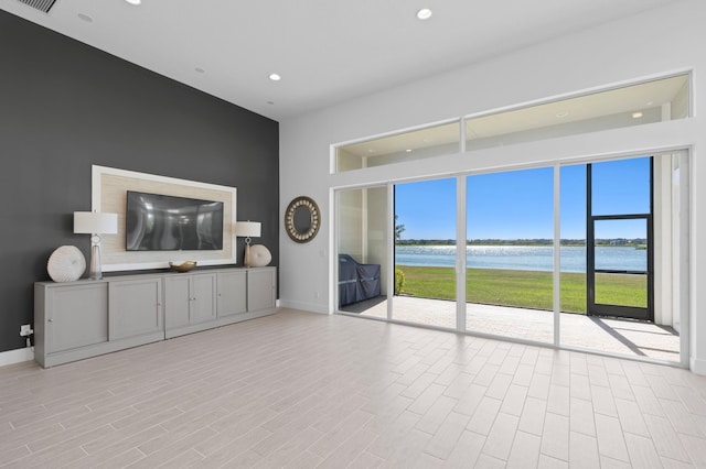 unfurnished living room featuring a wealth of natural light