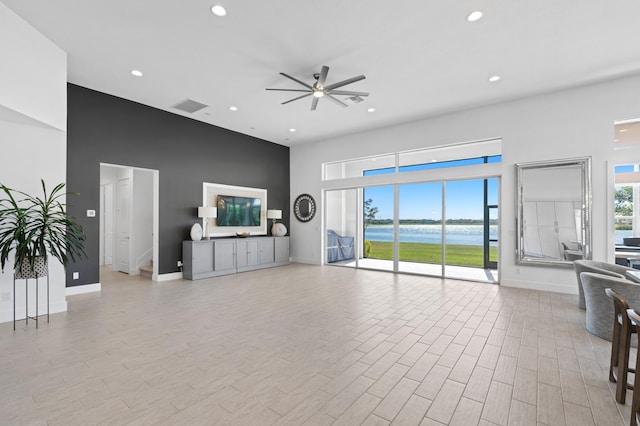 unfurnished living room featuring ceiling fan