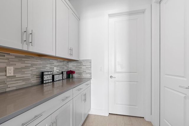 kitchen featuring white cabinetry and tasteful backsplash