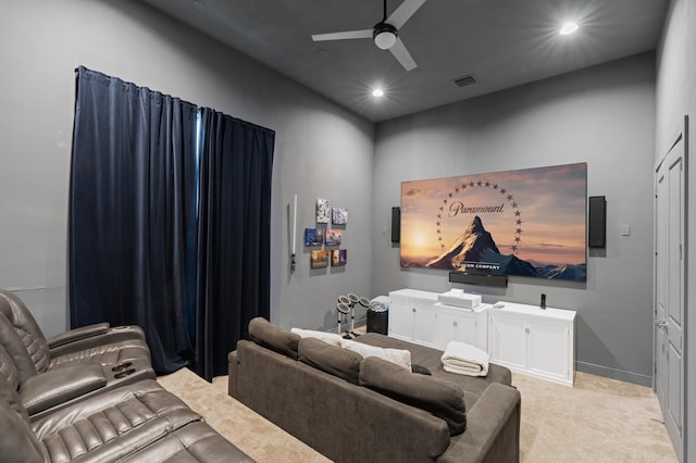 carpeted home theater featuring ceiling fan