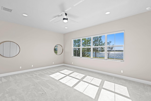 spare room with light carpet and ceiling fan