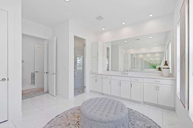 bathroom featuring an enclosed shower and vanity