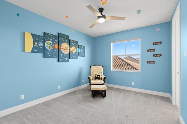 sitting room with carpet flooring and ceiling fan