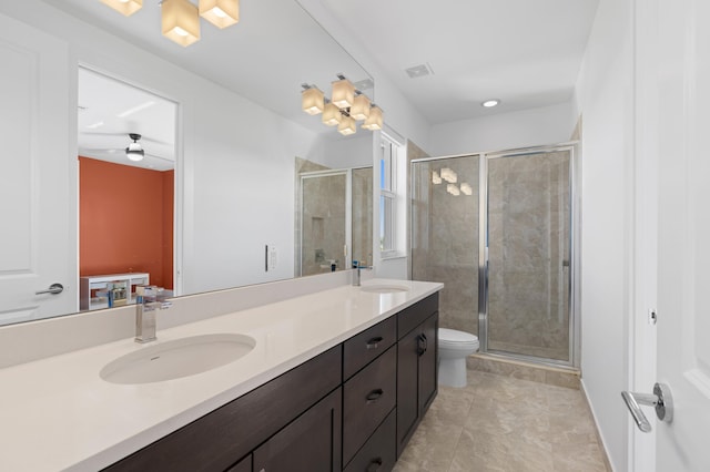 bathroom featuring toilet, a shower with door, vanity, and tile patterned flooring