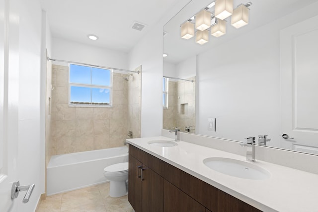 full bathroom with toilet, vanity, tile patterned flooring, and tiled shower / bath